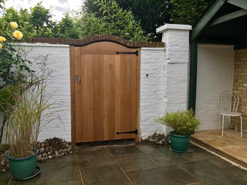 Bespoke oak garden gate set into traditional brickwork
