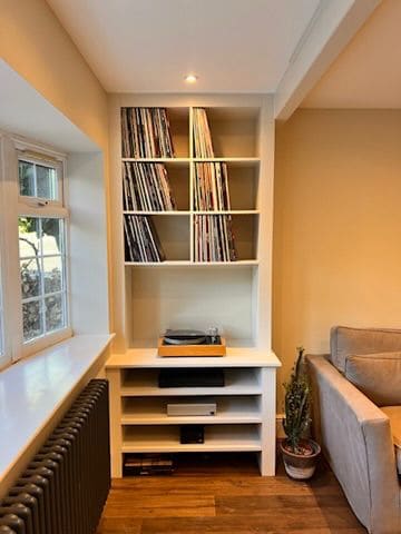 Built-in shelving and storage beside a window in a living room